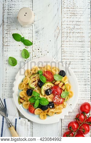 Pasta Fiocchi Salad With Vegetables Grilled Zucchini, Cherry Tomato, Olives, Basil And Parmesan Chee