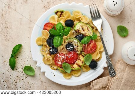 Pasta Fiocchi Salad With Vegetables Grilled Zucchini, Cherry Tomato, Olives, Basil And Parmesan Chee