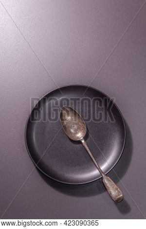 Dark Ceramic Plate And Vintage Spoon As A Table Settings Style