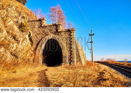 Tunnel On Circum Baikal Railway Running Along The Shore Of Lake Baikal On An Autumn Sunny Day With A