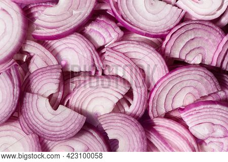 Sliced Purple Onions. Spanish Red Onion Slices. Horizontal Slicing. Background