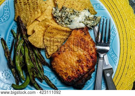 Marinated Char-grilled Pork Chops With Green Beans And Artichoke Spinach Dip