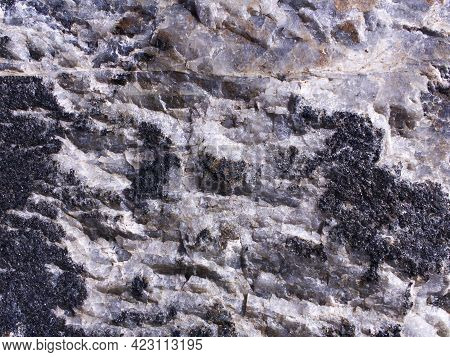 Stone Texture Of Black White And Gray Colors. Rough Rock Surface. Natural Material Background. Bould