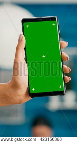 Hands Of Freelencer Holding Vertical Mock Up Green Screen Chroma Key Smartphone. Business Woman Usin