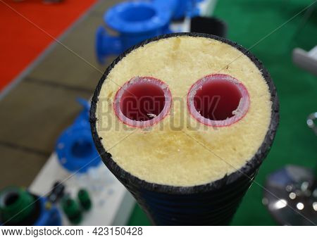 A Close-up Of Red Hot Water Plastic Pipes, Pex Tubing, Insulated In One Pipe. Pre-insulated Pipes Wi