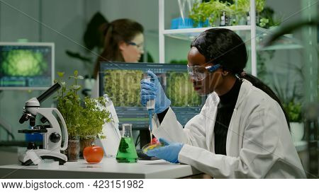 Biologist Scientist African Woman Researcher Taking Genetic Solution From Test Tube With Micropipett