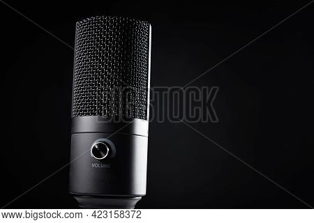 Studio Microphone On Dark Background With Copy Space. Black Professional Condencer Microphone, Close