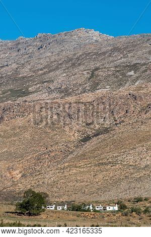 Seweweekspoort, South Africa - April 6, 2021: Farm Worker Houses At The Foot Of The Swartberg Mounta