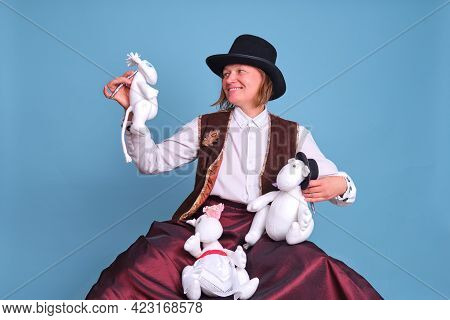 Actors With Moomin Troll Dolls On A Blue Background - Moscow, Russia, April 28, 2021