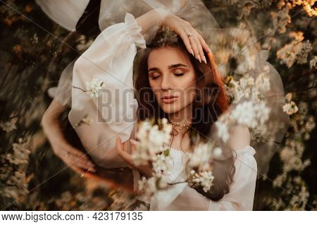 Portrait Of A Romantic Girl, Like A Forest Fairy, In A Blooming Garden With Elements Of Phantasmagor