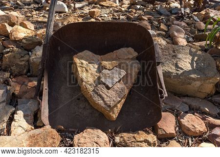 Heart-shaped Rocks Inside A Large Metal Scoop On A Farm Near The Top Of Seweweekspoort In The Swartb