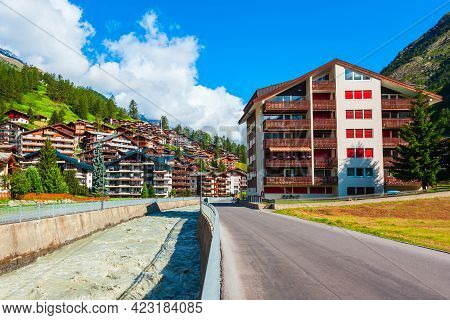 Traditional Local Houses Near The Matter Vispa River In The Centre Of Zermatt Town In The Valais Can