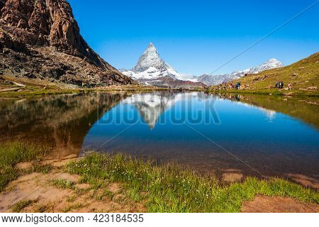 Riffelsee Lake And Matterhorn Mountain In The Alps, Located Between Switzerland And Italy