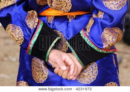 Hands Behind  Back Of A Man In Blue Mongolian Garment