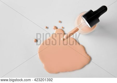 Mockup Glass Bottle Of Correction Cosmetic Product With Pipette. Spilled Liquid Foundation. Beauty B