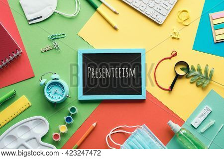 Presenteeism Term Written On Blackboard. School Supplies Office Supplies, Keyboard, Mouse, Alarm Clo