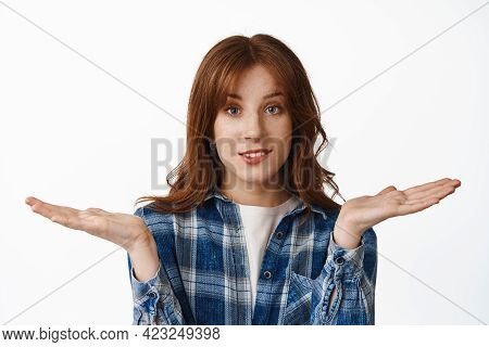 Silly Redhead Girl Shrugging Shoulders And Bite Lip, Dont Know Nothing, Have No Idea, Standing Cluel