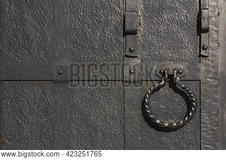 An Old Wrought Metal Gate With Handle, Doorknock, Deadbolt, Can Be Used As A Background