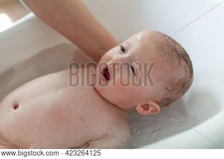 Little Baby Is Being Bathed By His Mother. Cute Baby During Bath Time