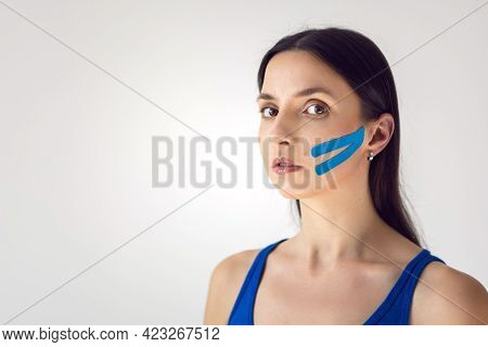 Portrait Of A Young Woman With Pasted Konesiotape For Rejuvenation And Face Tightening