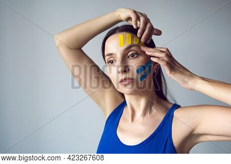 Portrait Of A Young Woman With Pasted Konesiotape For Rejuvenation And Face Tightening