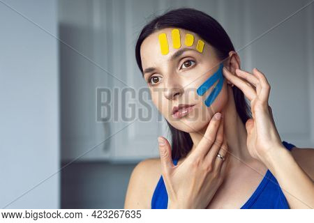 Portrait Of A Young Woman With Pasted Konesiotape For Rejuvenation And Face Tightening