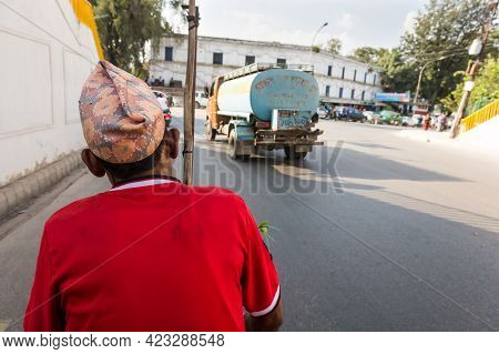 Rikshaw Driver On A Road Wearing Red Shirt.