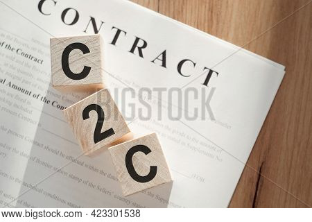 C2c Abbreviation - Consumer To Consumer, On Wooden Cubes On Background Of Contract.