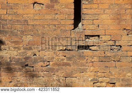 A Loophole In An Old Stone Wall. The Fortification Stone Wall Of An Ancient Castle With Loopholes. B