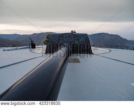 Tourist Woman On Bateria De Castillitos In Spain Cartagena, Cabo Tinoso. Military Cannon For Coastal