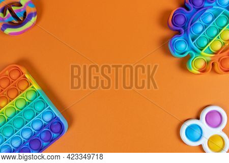Anti-stress Toys Pop It, Simple Dimple, Snapperz On Orange Background, Copy Space. Concept Trendy En