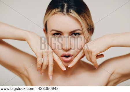 Woman Making Face Yoga Massage And Rejuvenating Exercises Facebuilding With Her Hands