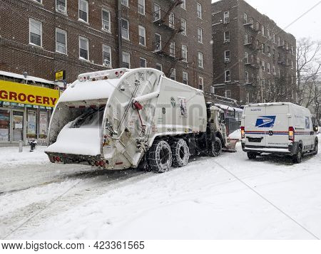 Bronx, New York/usa - February 1, 2021: Sanitation Truck Shovels Snow During Storm On Local Street.