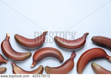 Tasty Red Baby Bananas On Light Blue Background, Flat Lay. Space For Text