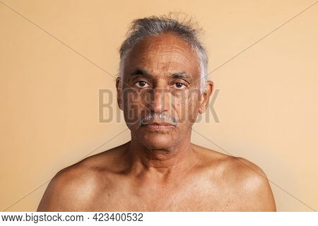 Bare chested mixed senior Indian man