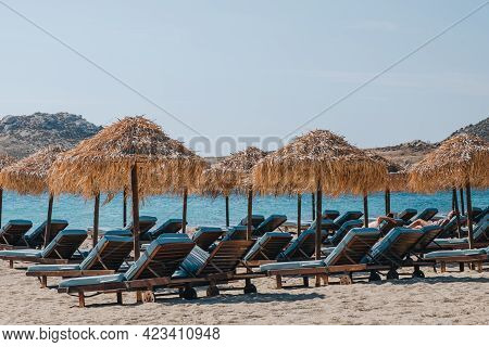 Kalafati, Greece - September 23, 2019: Blue Sun Beds Under Parasols On Kalafati Beach, A Popular Bea