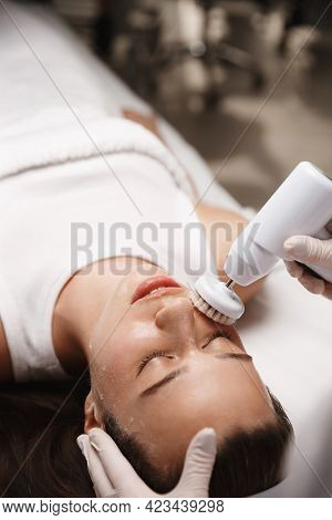 Hardware Cosmetology And Beauty Salon. Face Of Young Woman Lying At Beautician Clinic, Doctor Using 
