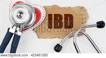Medicine And Health Concept. On A White Table Lie A Heart, A Stethoscope And A Cardboard With The In