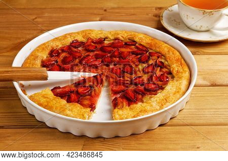 Homemade Open Pie Gallet With Strawberries And Rhubarb On Wooden Table. Shallow Focus.