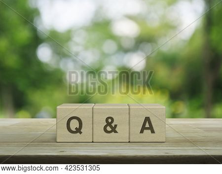 Q And A Letter On Block Cubes On Wooden Table Over Blur Green Tree In Park, Frequently Asked Questio