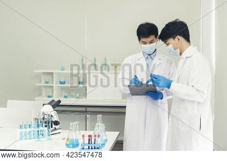 Two Asian Scientist Team Reserch Chemistry Science Tube Experiment Biotech Antibody Sample In Labora
