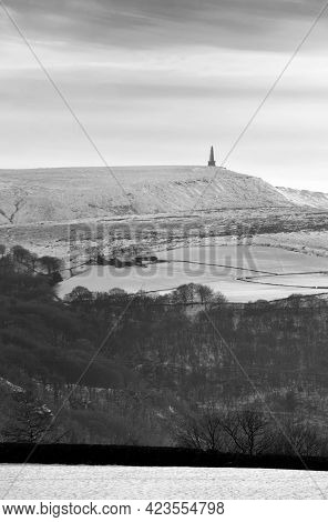 Snow Covered Fields With Stoodley Pike Monument And Moors In The Distance In Calderdale West Yorkshi