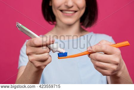 Beautiful Happy Young Woman With Toothbrush On Blank Pink Background