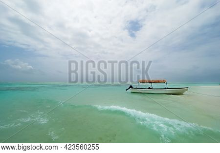 Shallow Atoll Sandbanks Turquoise Waves With Lonely Pleasure Boat Around Mnemba Island In The Indian
