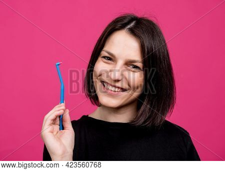 Beautiful Happy Young Woman With Single Tufted Toothbrush On Blank Pink Background