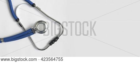 Metal Blue Sthethoscope On White Background With Copy Space. Medical Banner With Hospital Tool.