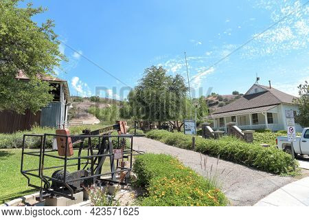 BREA, CALIFORNIA - 9 JUN 2021:  Shallow Well Pumping Lift at the Olinda Oil Museum, with main building, trail head and Jack Line Pump Unit building.