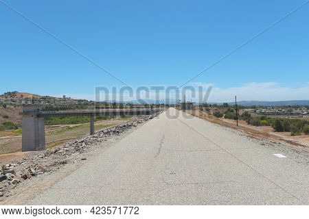 BREA, CALIFORNIA - 9 JUN 2021:  Road atop the Carbon Canyon Dam, constructed in 1959 as a response to Orange Countys growth and its need for flood control.