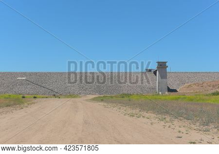BREA, CALIFORNIA - 9 JUN 2021: Dirt trail leading to The Carbon Canyon Dam, constructed in 1959 as a response to Orange Countys growth and its need for flood control.