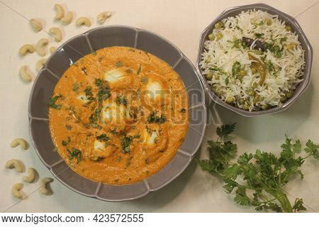 Egg Butter Masala And Green Peas Pulav. A Boiled Egg Dish With Rich Creamy Gravy Along With Green Pe